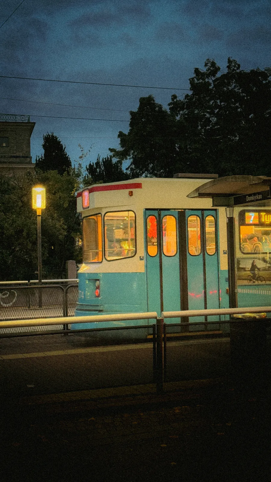 Blue and cream tram in Gothenburg at dusk
